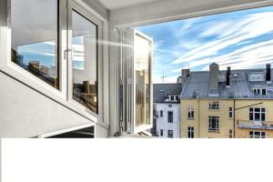 an open window with a view of a city at Exclusive, cosy, elegant Frogner apartment in the center of Oslo in Oslo