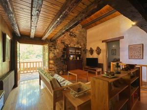 a living room with a couch and a table at Molí de Dalt in La Coma i la Pedra