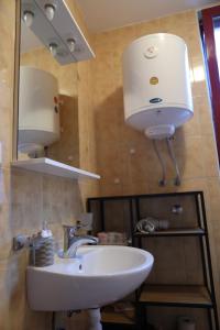 a bathroom with a sink and a mirror at Apartman 1 Zlaja Vlašić in Vlasic