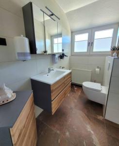a bathroom with a sink and a toilet at Exklusive Dorfpension mit Pool und Sauna in Lage