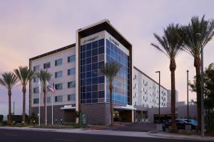 a building with palm trees in front of it at Element Irvine in Irvine