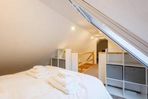 un letto bianco in una camera con mansarda di Exklusives Tiny House in Elbnähe a Buxtehude