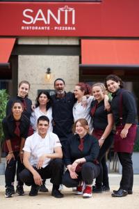 un groupe de personnes posant une photo devant un magasin dans l'établissement Luxury en-suite room Olympic Village in shared apartment, à Londres