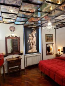 a bedroom with a red bed and a painting on the ceiling at La Torretta a 10 minuti dal lago di Garda in Castiglione delle Stiviere