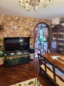 a living room with a table and a stove at La Torretta a 10 minuti dal lago di Garda in Castiglione delle Stiviere