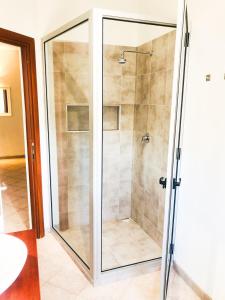 a shower with a glass door in a bathroom at Boavista Beach Apartment in Sal Rei