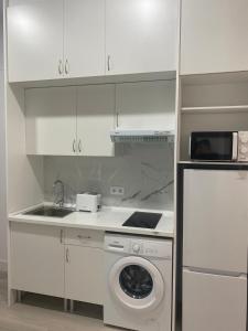 a kitchen with a washing machine and a sink at Moncloa apartment, con parking in Madrid