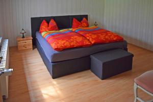 a bedroom with a bed with red pillows at Ferienwohnung Bömitz in Bömitz