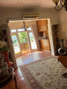 a living room with two doors and a rug at The KEDESAN Huis - Guest House in Johannesburg