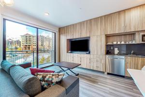 a living room with a couch and a large window at Canyons Resort Village #304 in Park City