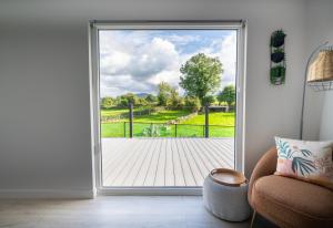 an open door with a view of a wooden deck at The Hideout in Newry