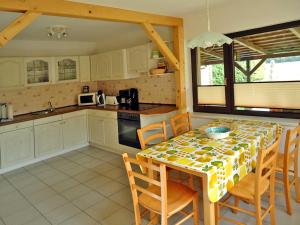 a kitchen with a table with chairs and a tablecloth at Ferienhaus am Klostergrund in Malchow