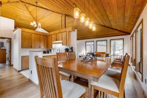 a dining room and kitchen with a wooden ceiling at Jackalope Manor in Sunriver