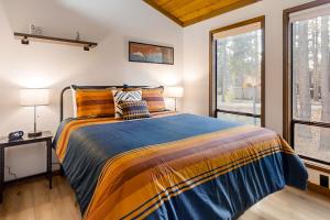 a bedroom with a bed and a large window at Jackalope Manor in Sunriver