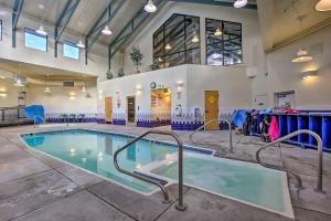 a swimming pool in a large room with a building at Mtn-View Condo with Community Perks in Silverthorne in Silverthorne
