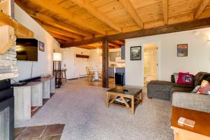a living room with a couch and a table at Mtn-View Condo with Community Perks in Silverthorne in Silverthorne