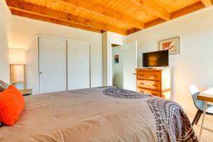 a bedroom with a bed and a desk and a television at Mtn-View Condo with Community Perks in Silverthorne in Silverthorne