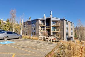 a building with a car parked in a parking lot at Mtn-View Condo with Community Perks in Silverthorne in Silverthorne