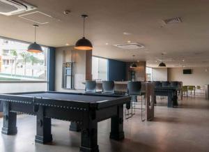 a large room with a pool table and chairs at Enjoy Solar das Águas Olímpia in Olímpia