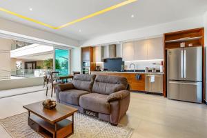 sala de estar con sofá y cocina en V Golf 601, en Puerto Vallarta