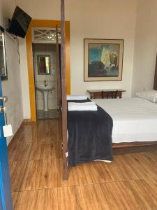 Postel nebo postele na pokoji v ubytování Suítes Casa da Colônia