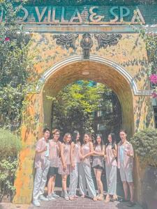a group of children standing under an archway at HELLO VILLA & SPA in Hue