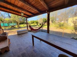 a porch with a hammock and a view of a park at Cabañas don graziano in Azul