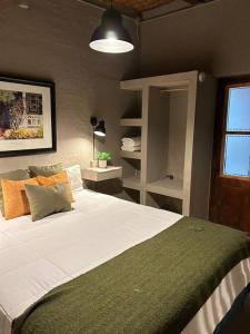 a bedroom with a large bed in a room at Aromos Lodge ll - Chacras de Coria in Ciudad Lujan de Cuyo