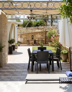 an outdoor patio with a black table and chairs at Amarlia Villa in Skaleta