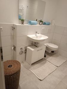 a bathroom with a sink and a toilet at L8 Street - Gneisenaustraße 9 in Pforzheim