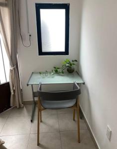 una scrivania con sedia e un tavolo con una pianta di Linda Habitación en el Centro a Querétaro