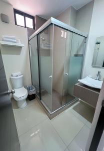 a bathroom with a shower and a toilet and a sink at Condominios Costa Diamante in San Carlos