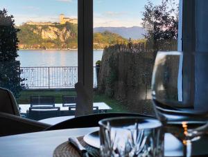 a table with a view of a lake from a window at FWL Italian Romance on the Lake in Arona