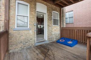 a patio with a blue box on a wooden deck at Game Day Getaway - 3BR in Vibrant Wrigleyville in Chicago