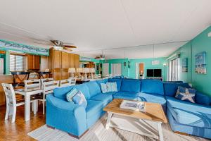 a living room with a blue couch and a table at Wight Bay North #439 in Ocean City