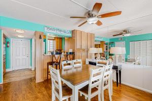 a dining room and kitchen with a table and chairs at Wight Bay North #439 in Ocean City