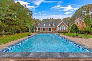 a swimming pool in the backyard of a house at East Quogue House in East Quogue
