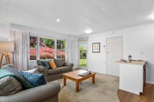 a living room with a couch and a table at Maratoa - Takaka Holiday Home in Takaka