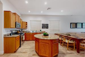 a large kitchen with wooden cabinets and a table at Serenity Now in Glendale