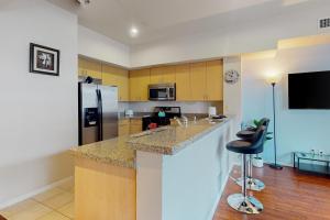 a kitchen with a counter and a refrigerator at The Heart of the City in San Diego