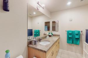 a bathroom with a sink and a mirror at The Heart of the City in San Diego