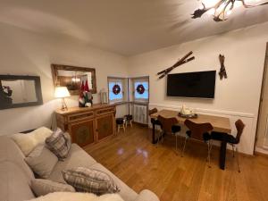 a living room with a couch and a table at Sweet Campiglio in Madonna di Campiglio