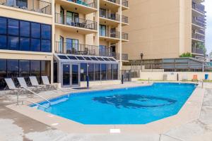 a swimming pool in front of a building at Phoenix IV 4052 in Orange Beach