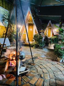 a fire pit in front of a house at Trầm Homestay in Thôn An Hòa