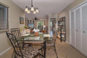 a kitchen and dining room with a table and chairs at Beautifully updated Sea Woods Condo near main pool and beach access - SC248 in Edgewater