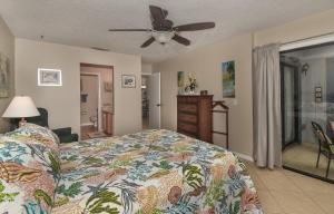a bedroom with a bed and a ceiling fan at Beautifully updated Sea Woods Condo near main pool and beach access - SC248 in Edgewater +27 photos