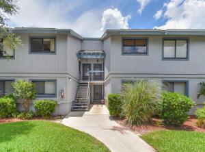 a large white house with a driveway at Beautifully updated Sea Woods Condo near main pool and beach access - SC248 in Edgewater