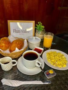 a table with a breakfast of coffee and croissants at Hotel Plaza Teatro in Chiclayo