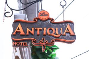 a sign for an antioch hotel hanging on a building at Lar Antiqua Hotel in Quetzaltenango