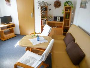 a living room with a couch and a table at Bungalow im Garten in Malchow